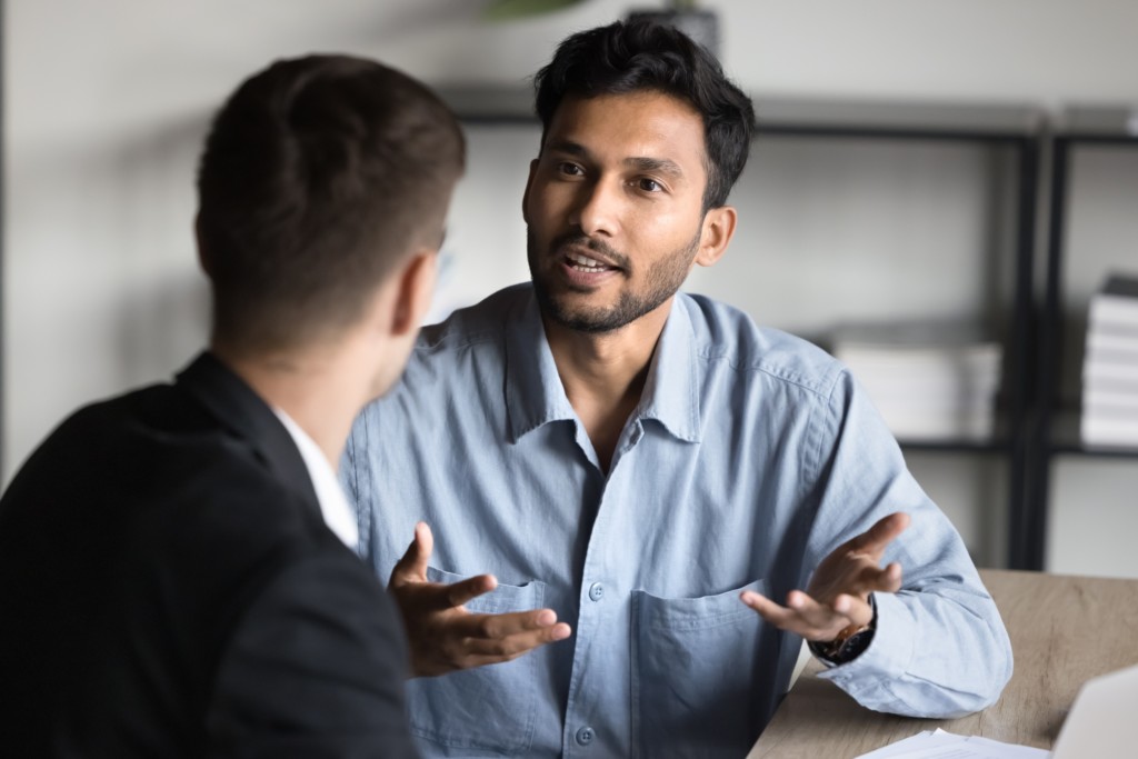 Two male colleagues communicating